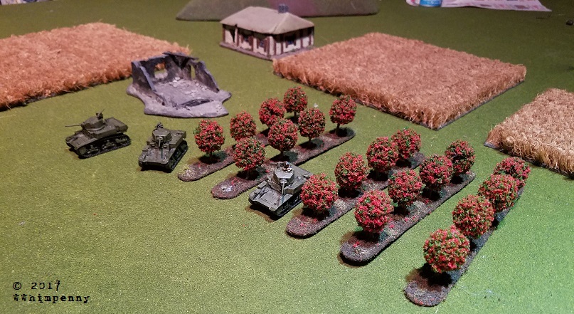 Completed Flames of War 15mm Orchard terrain with a platoon of US M3A1 Stuarts moving through it.